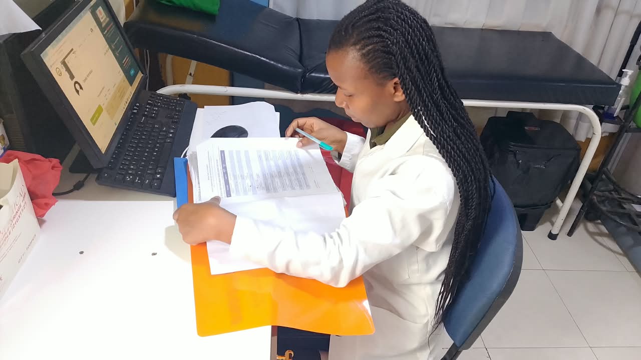 A Medpark clinician going through a patient's file in the consultation room